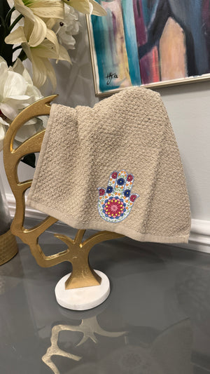 Beige hand towel designed with Fatima’s hand .