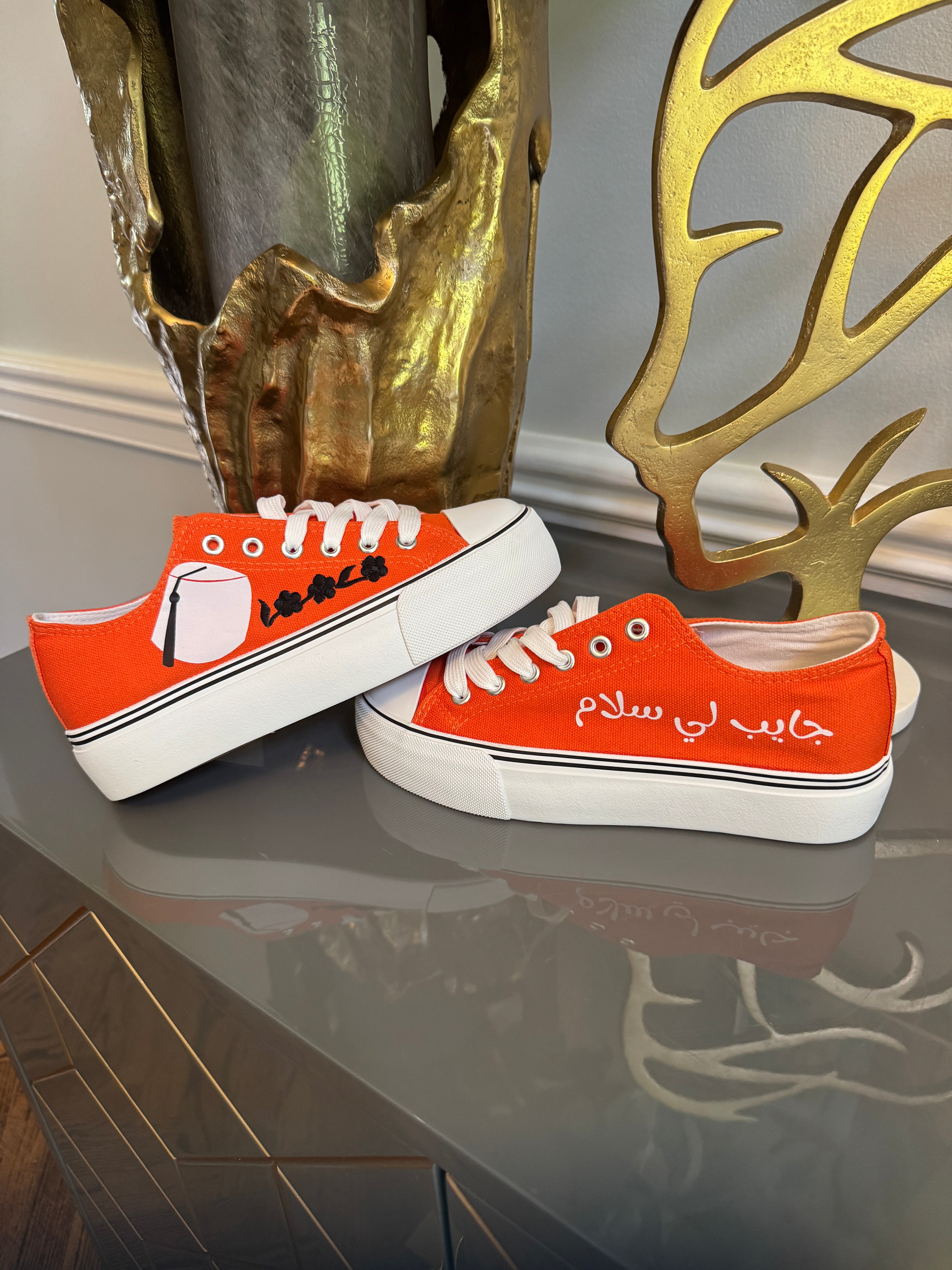 Orange Canvas Sneakers, designed with Arabic calligraphy جايب لي سلام and flower motifs