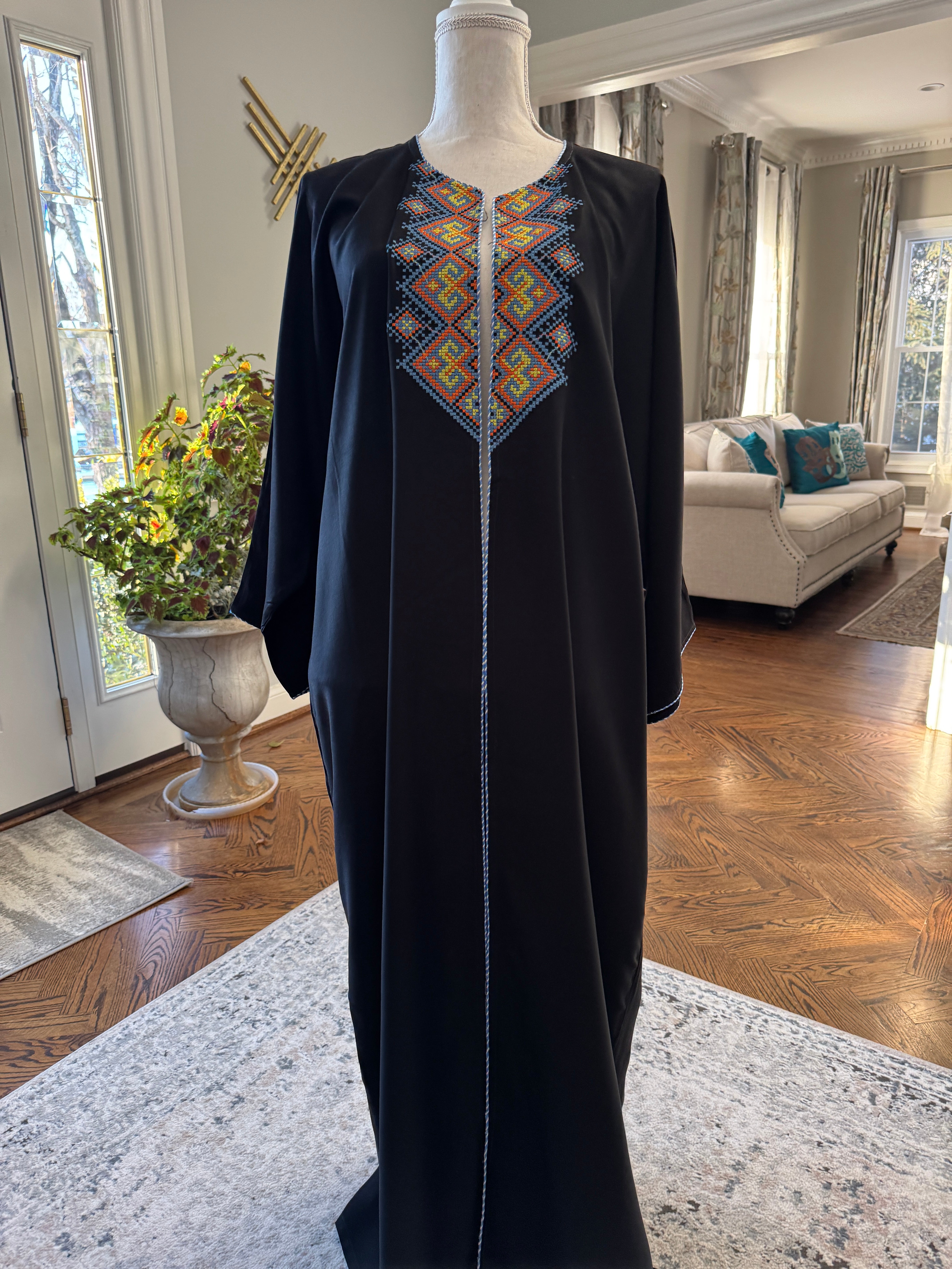 Black Open caftan embroidery design on the front. Designed with fun Arabic Calligraphy Unique design on the back. عليك عين، عندك سفرة، شايفي عريس