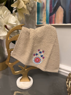 Beige hand towel designed with Fatima’s hand .