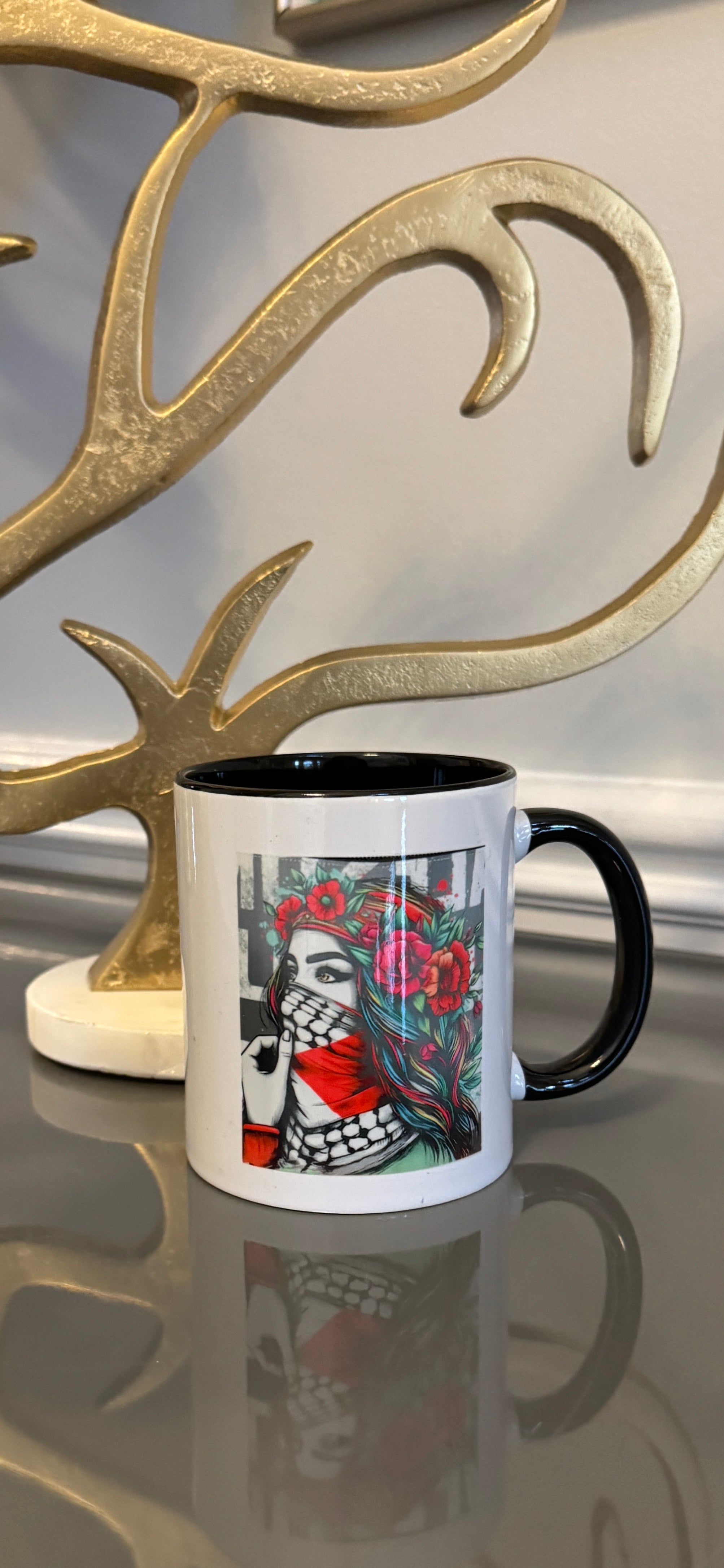 White mug designed with a powerful women image wearing the keffiyeh.