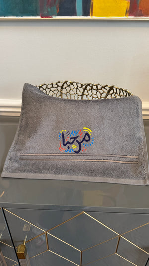 Gray towel designed with artistic Arabic Calligraphy مرحبا “marhaba”