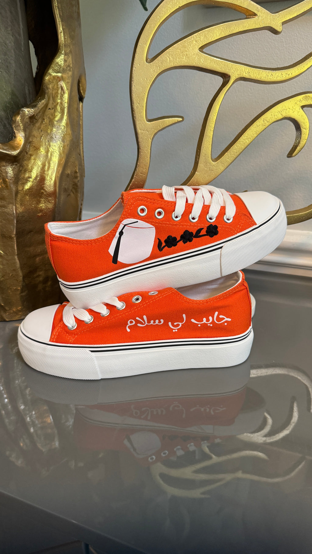 Orange Canvas Sneakers, designed with Arabic calligraphy جايب لي سلام and flower motifs