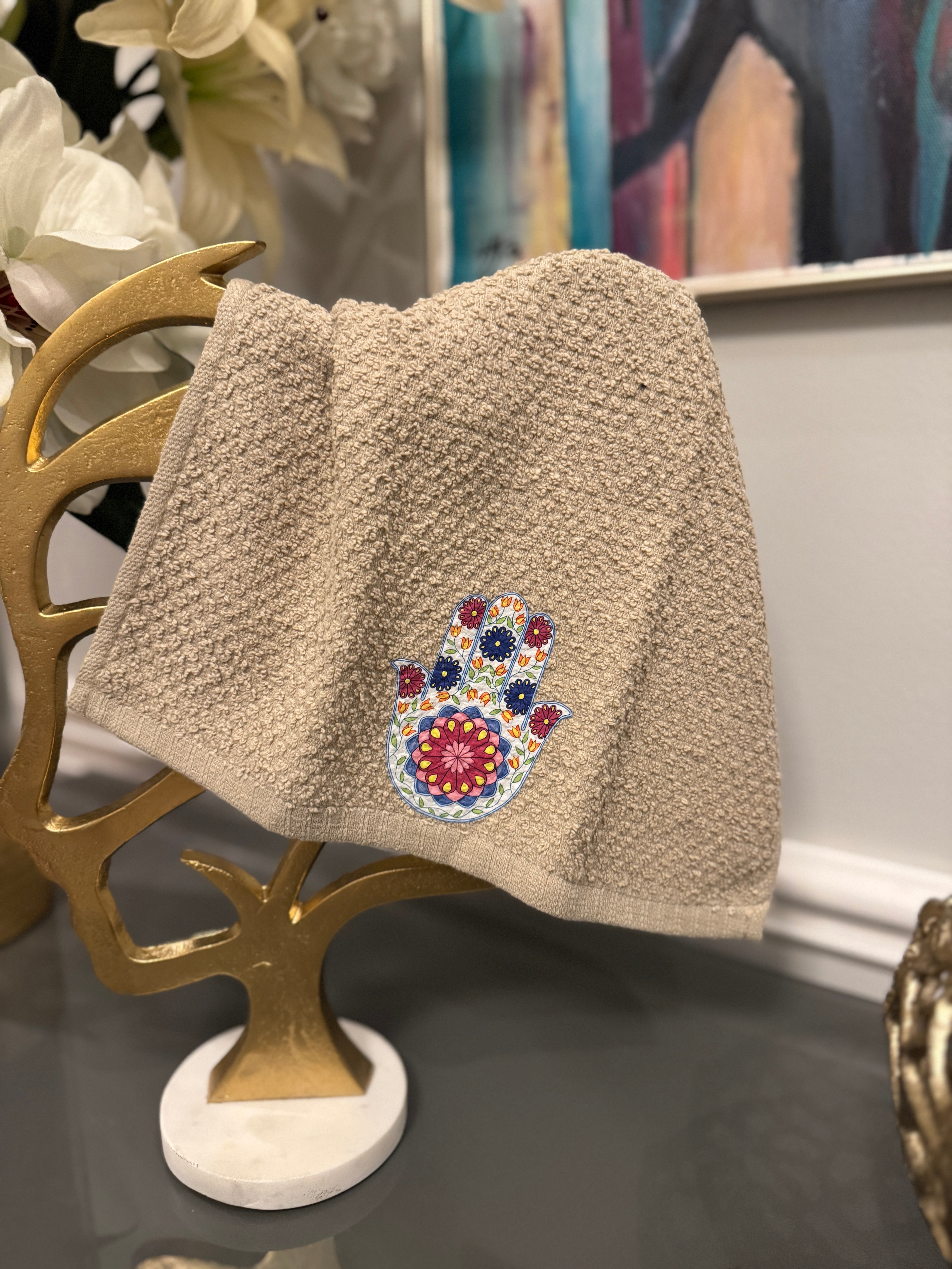 Beige hand towel designed with Fatima’s hand .