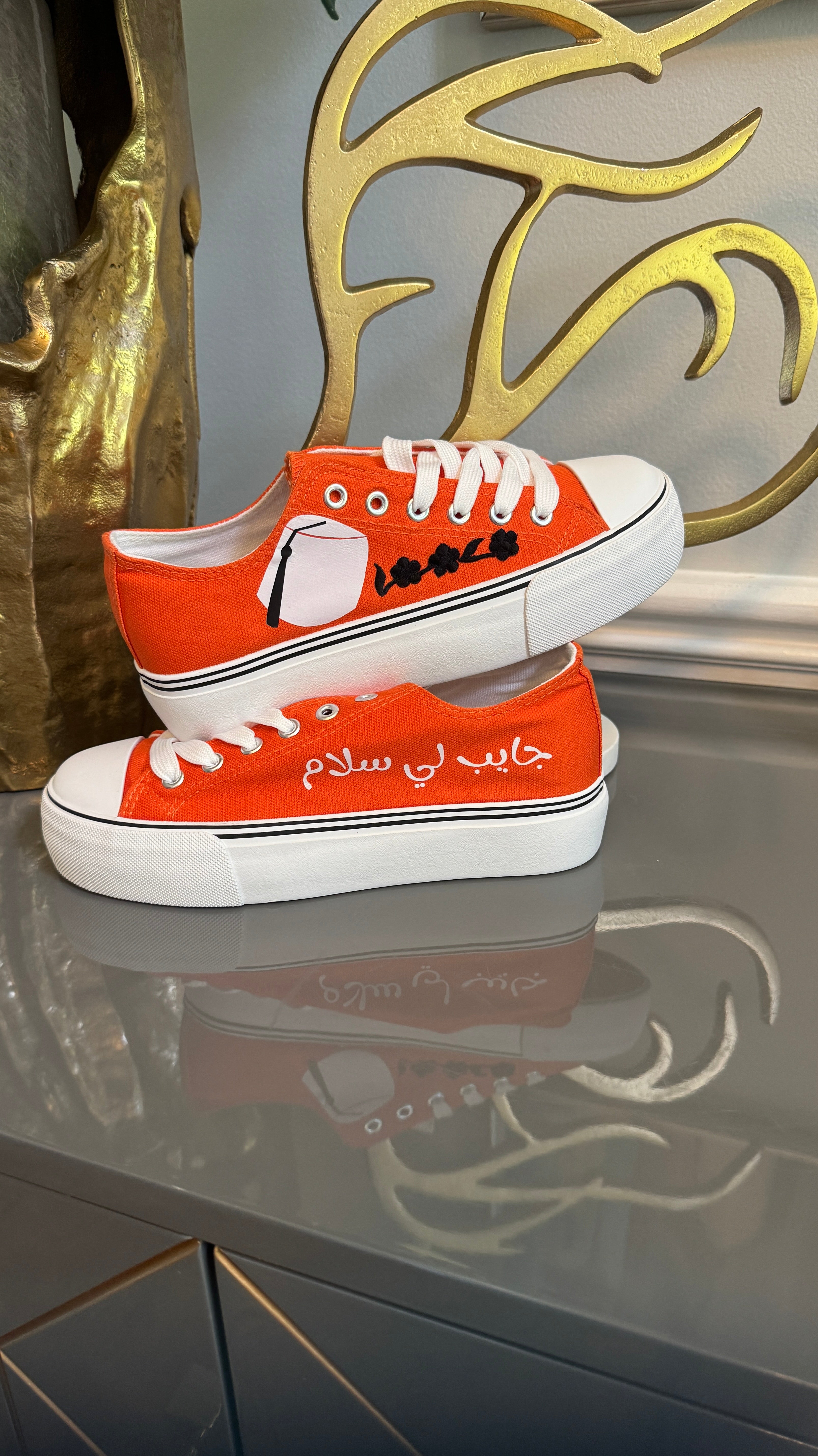 Orange Canvas Sneakers, designed with Arabic calligraphy جايب لي سلام and flower motifs