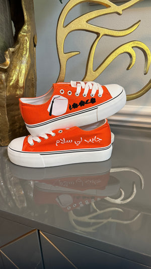 Orange Canvas Sneakers, designed with Arabic calligraphy جايب لي سلام and flower motifs