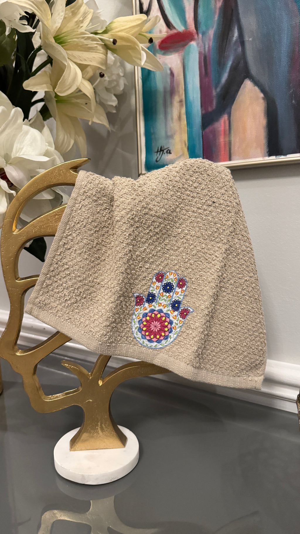 Beige hand towel designed with Fatima’s hand .