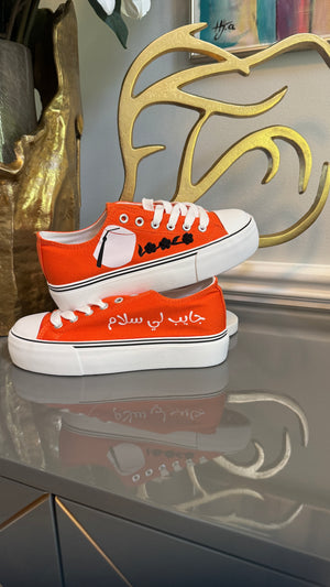 Orange Canvas Sneakers, designed with Arabic calligraphy جايب لي سلام and flower motifs