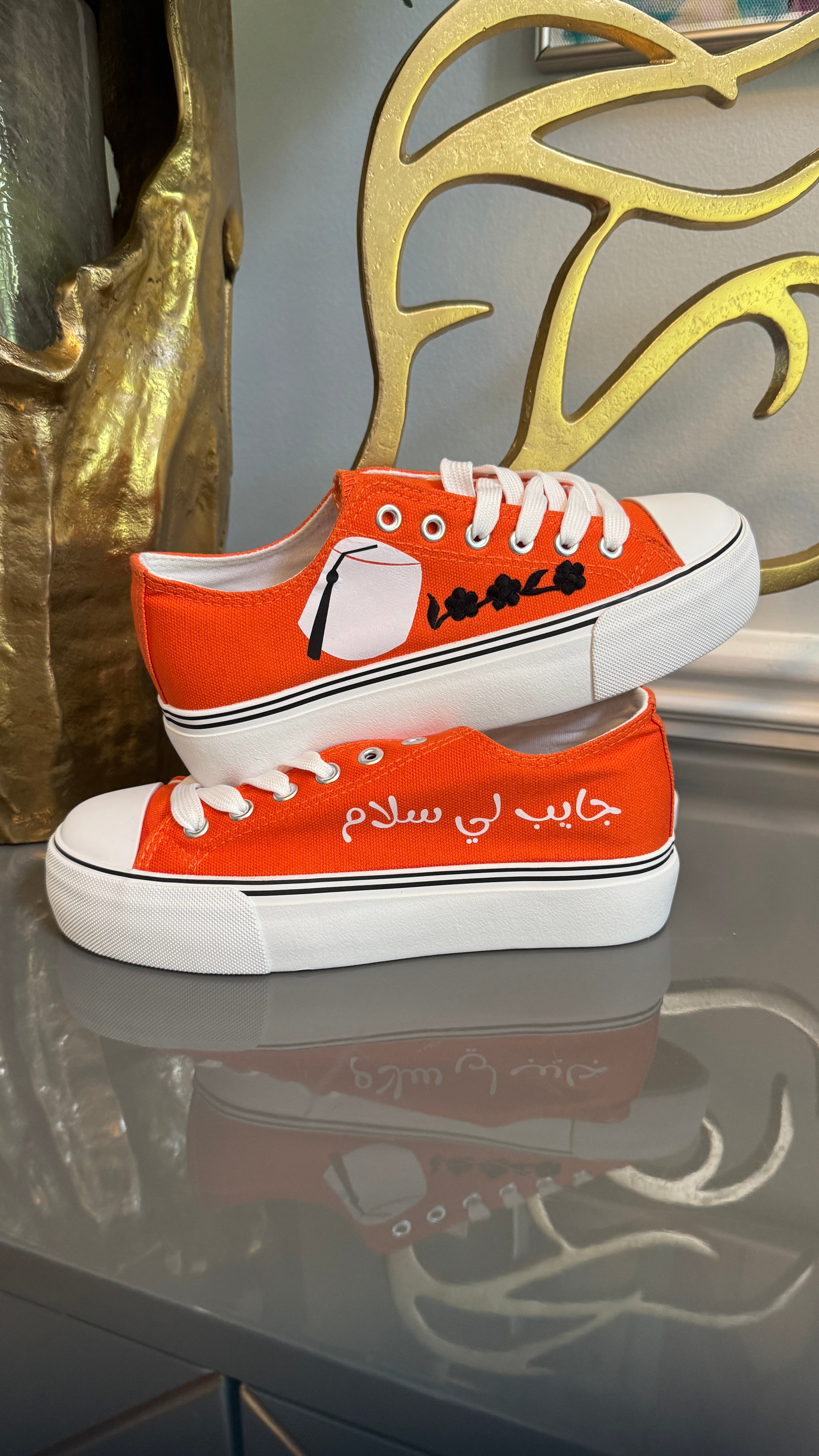Orange Canvas Sneakers, designed with Arabic calligraphy جايب لي سلام and flower motifs