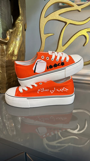 Orange Canvas Sneakers, designed with Arabic calligraphy جايب لي سلام and flower motifs