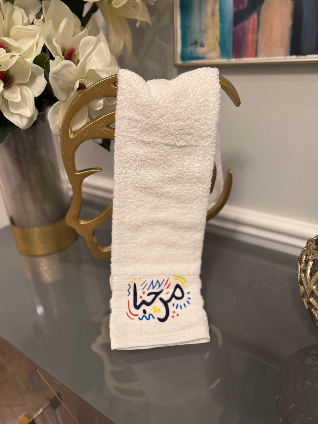 White towel designed with artistic Arabic Calligraphy مرحبا “marhaba”