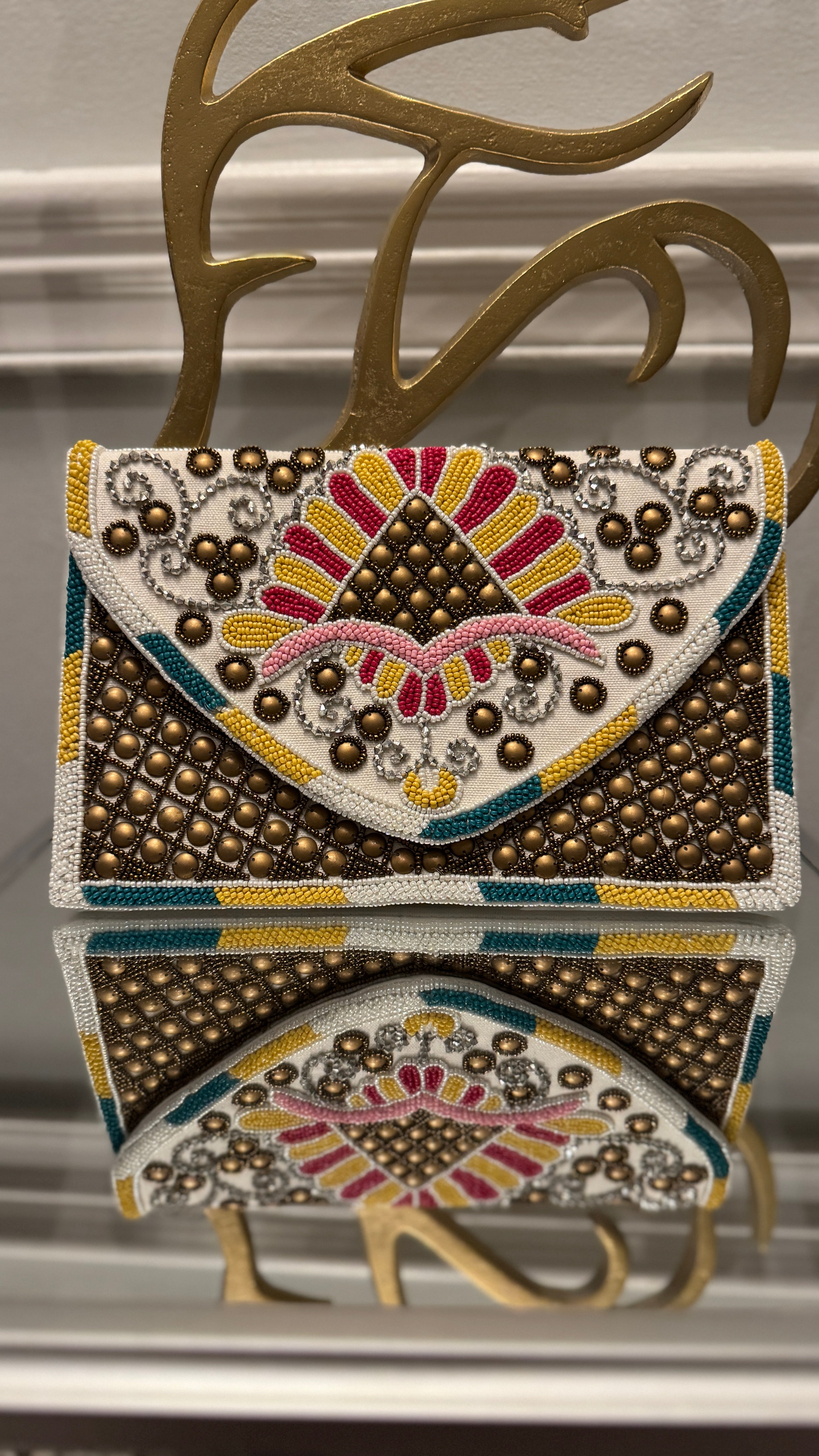 Hand beaded multi-colored with bronze studs clutch